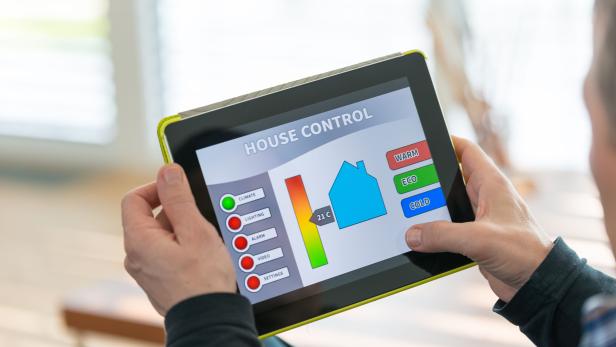Man using digital tablet for remote house control