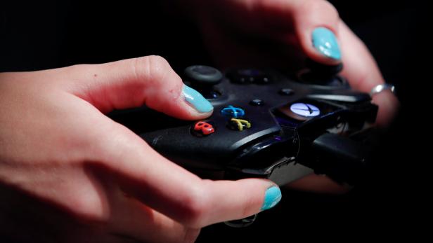Gamer uses an XBox One game controller at Gamescom in Cologne