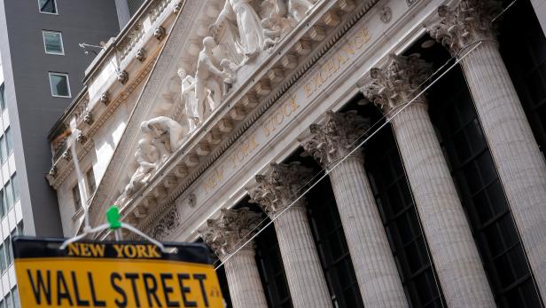 A novelty Wall St. sign is displayed at a stand outside the NYSE in New York