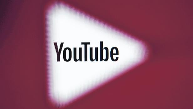 FILE PHOTO:    A 3D-printed YouTube icon is seen in front of a displayed YouTube logo in this illustration