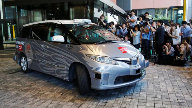 ZMP Inc's RoboCar MiniVan, a self-driving taxi based on a Toyota Estima Hybrid car, operated by Hinomaru Kotsu Co, is seen at the start of its services proving test in Tokyo