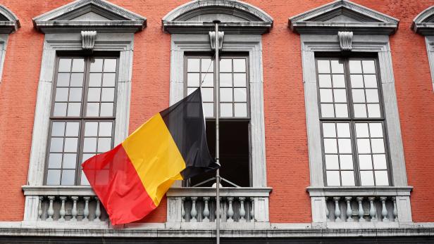 A Belgian flag flies half mast in tribute of the victims after a shooting, in Liege