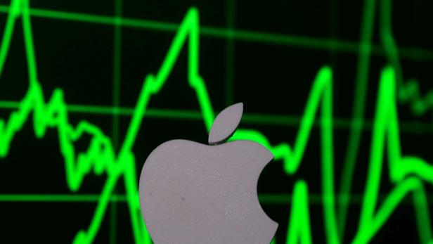 FILE PHOTO: A 3D printed Apple logo is seen in front of a displayed stock graph in this photo illustration
