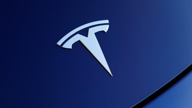 The front hood logo on a 2018 Tesla Model 3 electric vehicle is shown in Cardiff, California