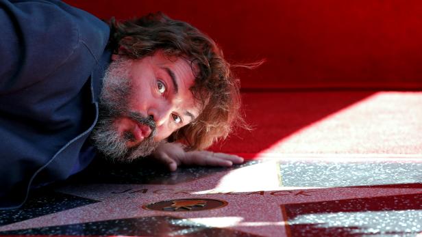 Actor Jack Black kisses his star at its unveiling on the Hollywood Walk of Fame in Los Angeles