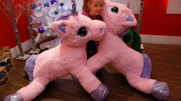 Aston Robertson-Jeyes, aged 3, plays with Unice Unicorn, at the launch of Hamleys top Christmas toys launch in London