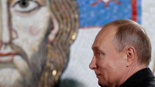 Russian President Vladimir Putin stands during his visit to the St Sava temple in Belgrade