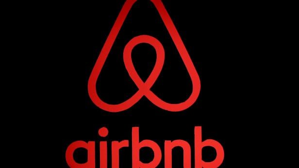 FILE PHOTO: The logo of Airbnb is displayed at an Airbnb event in Tokyo
