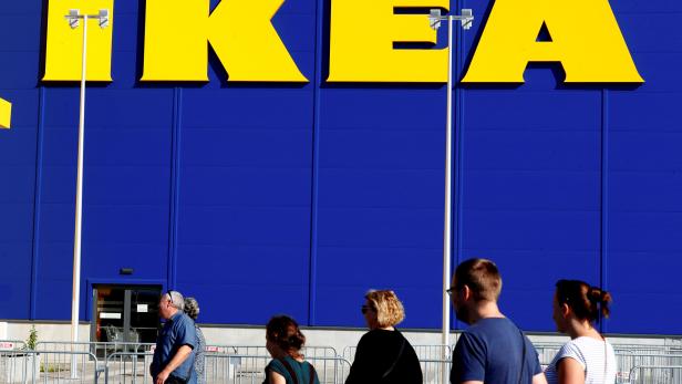 FILE PHOTO: People walk past an IKEA sign as they visit the company's new store in Riga