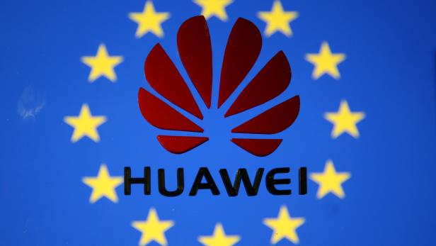 A 3D printed Huawei logo is placed on glass above displayed EU flag in this illustration taken