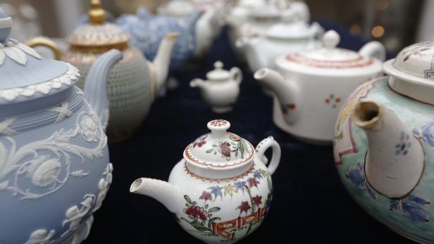 A rare Vauxhall minitature polychrome teapot (dated c.1760) is pictured with some of the Hanley Collection of Teapots at Sotheby's auction house in London