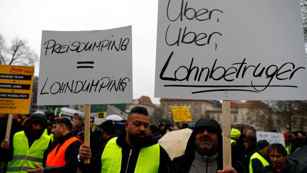 Licensed taxi drivers protest against a planned change of the passenger transport law in front of the Federal Department of Transportation in Berlin