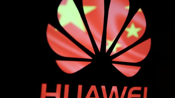 A 3-D printed Huawei logo is seen in front of displayed flag of China in this illustration