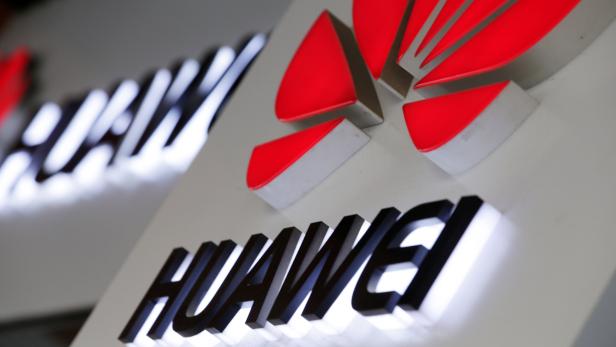Logos of Huawei are pictured outside its shop in Beijing