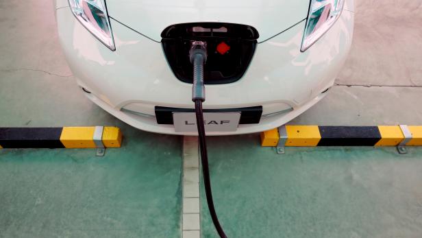 FILE PHOTO: An electric car is seen while being charged during the opening of a PTT Pcl energy firm's commercial EV charging station, in Bangkok