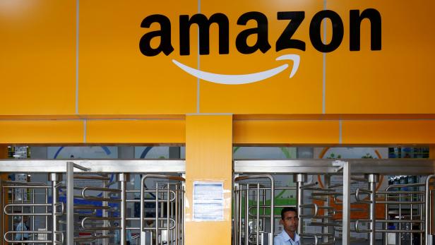 FILE PHOTO: An employee of Amazon walks through a turnstile gate inside an Amazon Fulfillment Centre (BLR7) on the outskirts of Bengaluru