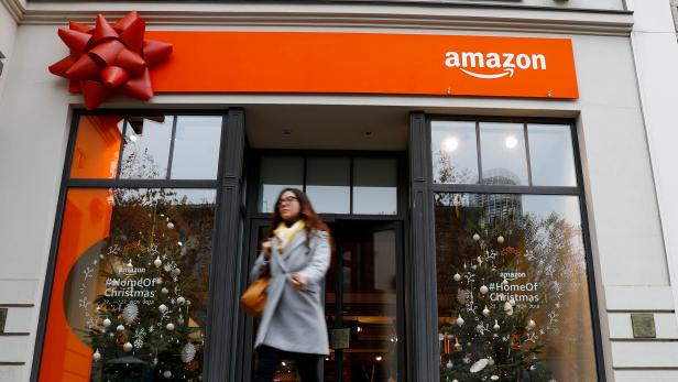 A customer leaves a new Amazon pop-up store for Christmas at Berlin's main shopping street Kurfurstendamm boulevard in Berlin