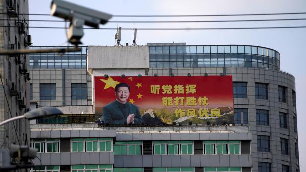 FILE PHOTO: Poster with a portrait of Chinese President Xi is displayed in Shanghai