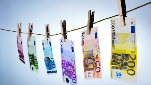 Euro cash notes hanging from a clothesline