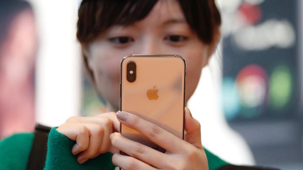 A customer looks at Apple's new iPhone XS after it went on sale at the Apple Store in Tokyo