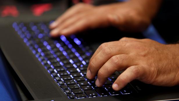 A man types into a keyboard during the Def Con hacker convention in Las Vegas