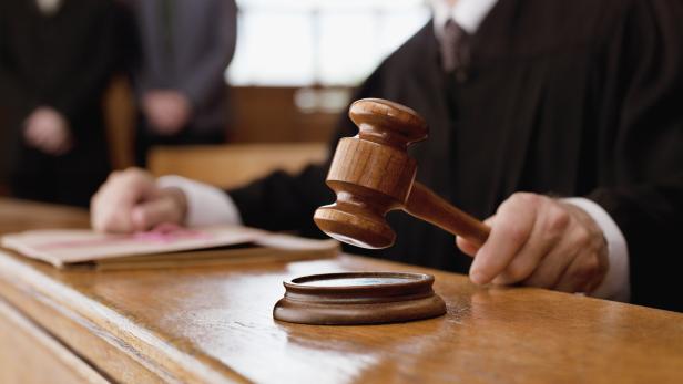 Judge holding gavel in courtroom