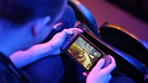A fan plays Rocket League on a Nintendo Switch during day one of the Rocket League Championship Series Finals in London