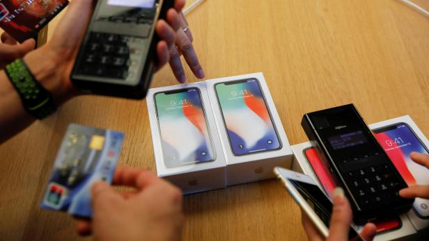 FILE PHOTO: New iPhone X phones are purchased at an Apple Store in Beijing