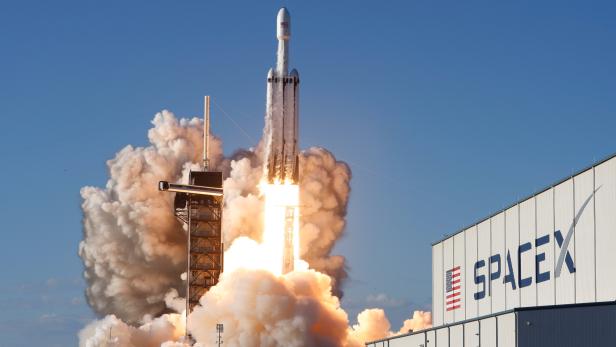A SpaceX Falcon Heavy rocket, carrying the Arabsat 6A communications satellite, lifts off from the Kennedy Space Center