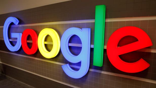 FILE PHOTO: An illuminated Google logo is seen inside an office building in Zurich