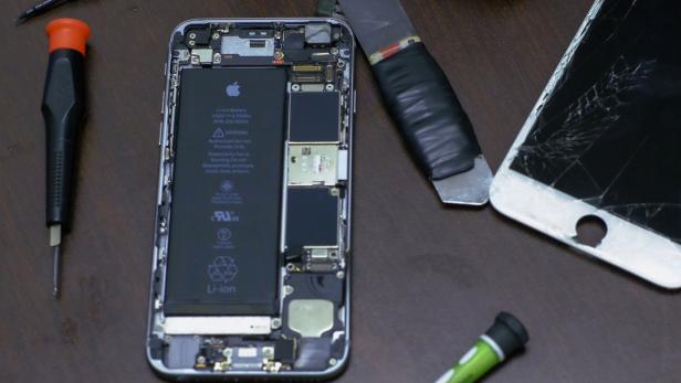 Pieces of an iPhone are seen in a repair store in New York