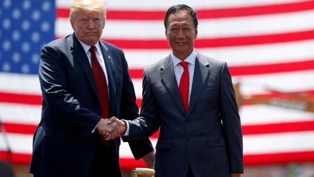 FILE PHOTO:  U.S. President Donald Trump shakes hands with Foxconn Chairman Terry Gou during a grond breaking at Foxconn's new site in Mount Pleasant