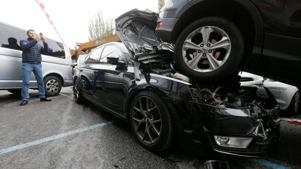 A man takes pictures at the site of a road traffic accident after a mobile crane crashed into passenger vehicles in Kiev