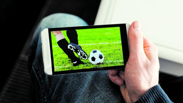Watching a football match live streamed on mobile phone