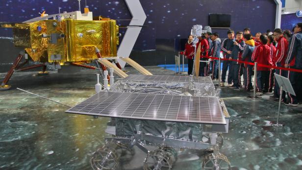 Model of the lunar rover Yutu-2, or Jade Rabbit 2, is displayed next to a model of the moon lander for Chang'e 4 lunar probe, at an aerospace exhibition in Yantai