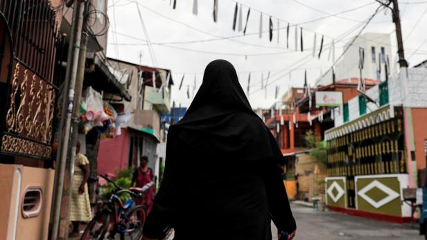 A Muslim woman wearing a hijab walks through a street near St Anthony's Shrine in Colombo