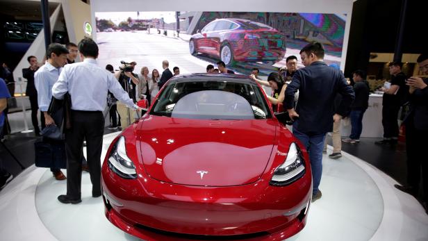FILE PHOTO: A Tesla Model 3 car is displayed during a media preview at the Auto China 2018 motor show in Beijing