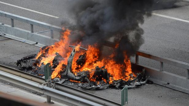 An electric-powered Tesla car burns after a crash on the Swiss A2 motorway on Monte Ceneri near Bellinzona
