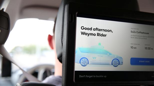 One of three screens displays the user interface inside a Waymo self-driving vehicle, during a demonstration in Chandler, Arizona