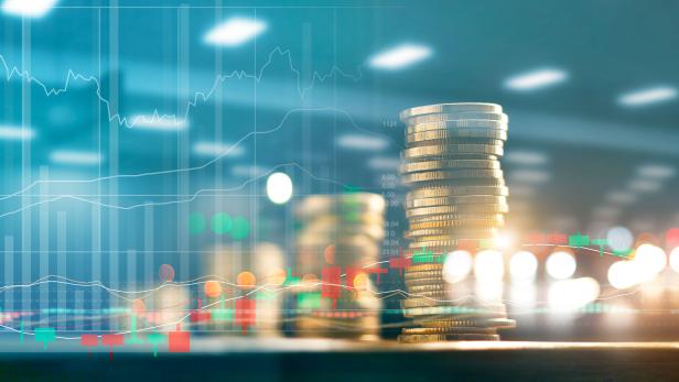 Finance and business investment concept. Graph and rows with statistic growth of coins on table.