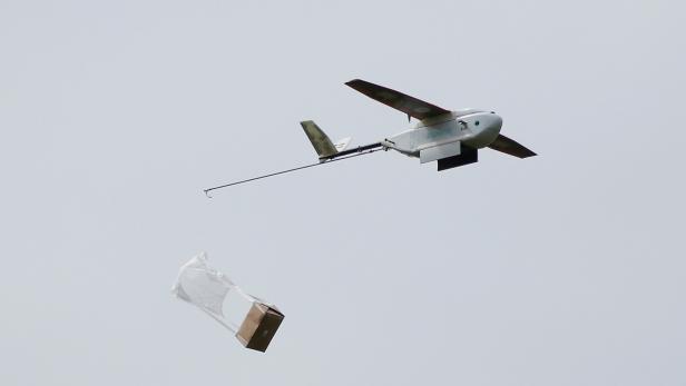 A Zipline delivery drone releases its payload midair during a flight demonstration at an undisclosed location in the San Francisco Bay Area, California