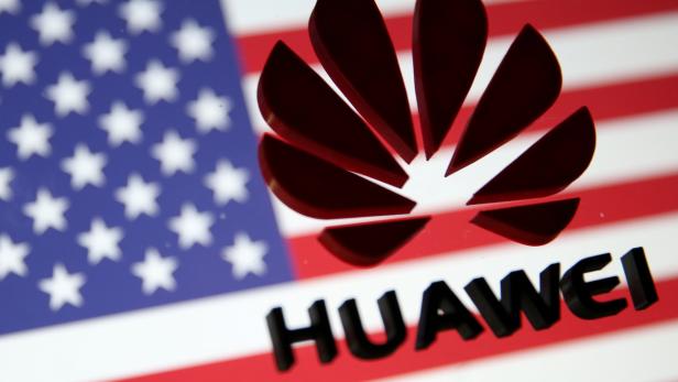 FILE PHOTO: A 3D printed Huawei logo is placed on glass above displayed U.S. flag in this illustration