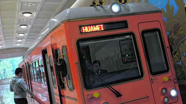An employee enters a train in the Huawei's Ox Horn campus at Songshan Lake in Dongguan, Guangdong province