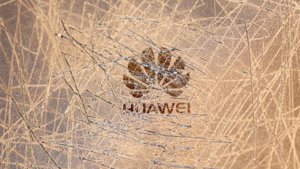 FILE PHOTO: A scratched surface Huawei logo is seen on a smarthphone in this illustration picture
