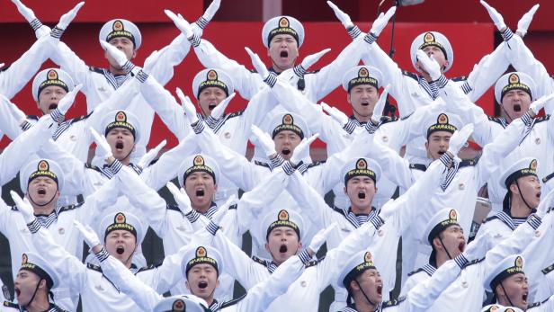 Chinese navy personnel perform at an event celebrating the 70th anniversary of the founding of the Chinese People's Liberation Army Navy (PLAN) in Qingdao