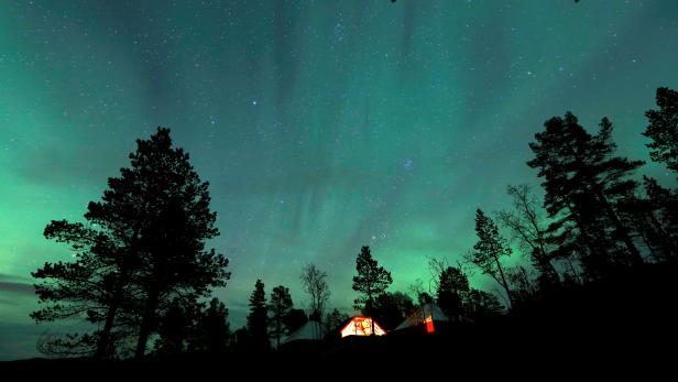 FILE PHOTO: The Aurora Borealis (Northern Lights) is seen over a mountain camp north of the Arctic Circle