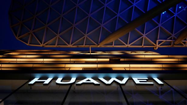 FILE PHOTO: A Huawei company logo is seen at a shopping mall in Shanghai