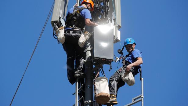 Technicians install 5G antennas of Swiss telecom operator Swisscom in Lenzerheide