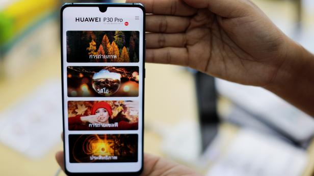 A vendor displays a Huawei P30 Pro mobile at the Mobile Expo in Bangkok
