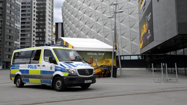 Police vans stand in front of the Friends Arena in Solna, outside Stockholm